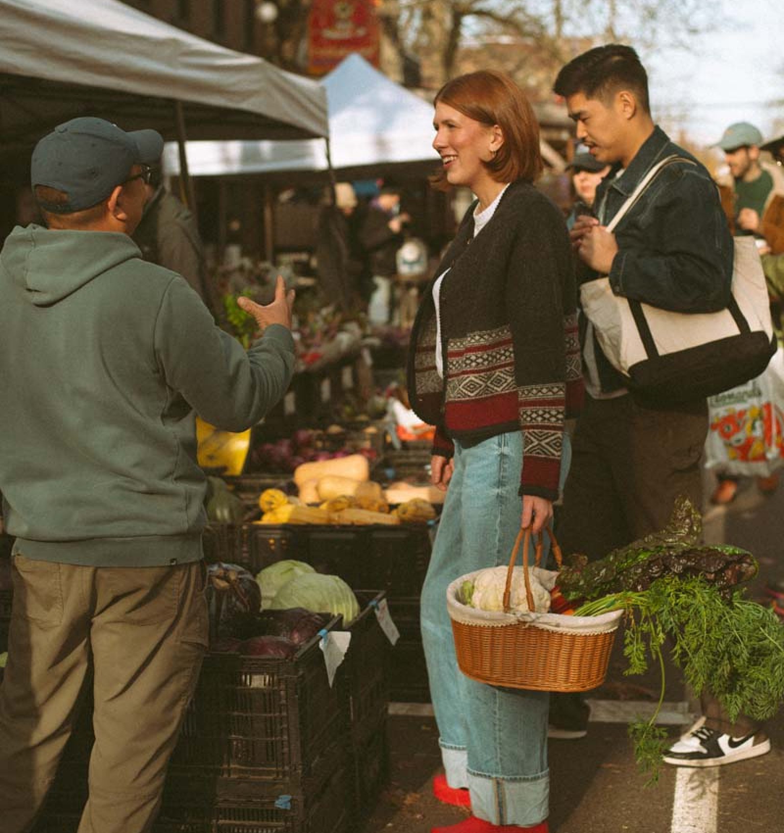 Red Clog Kitchen shopping at Ballard Farmer's market, talking to a local farmer